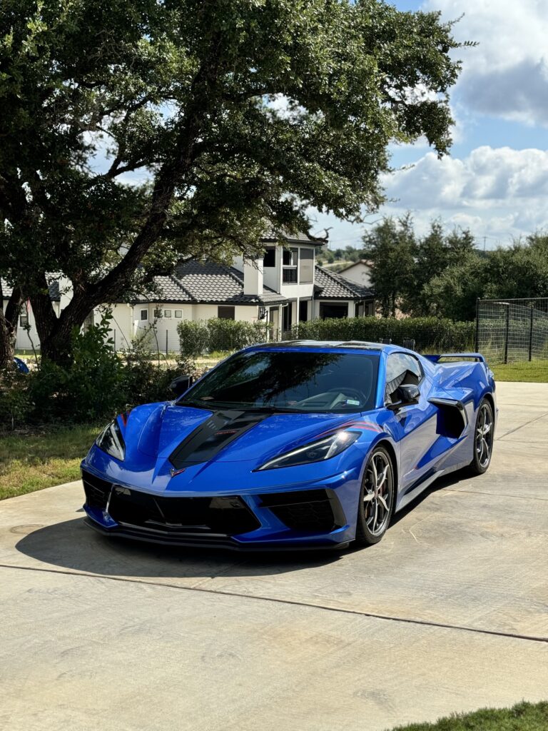 Blue Corvette after ceramic coating in a San Antonio driveway