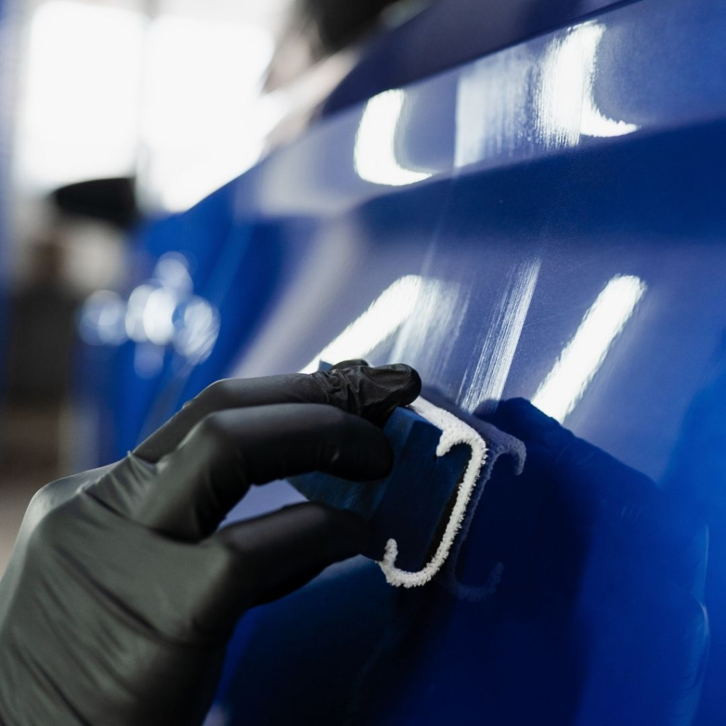 Detailer applying protection to paint with a microfiber applicator